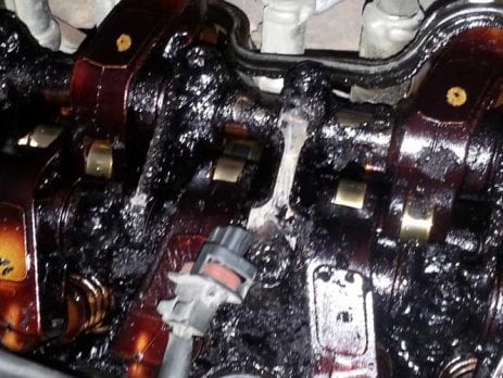 engine covered in a bad oil sludge buildup
